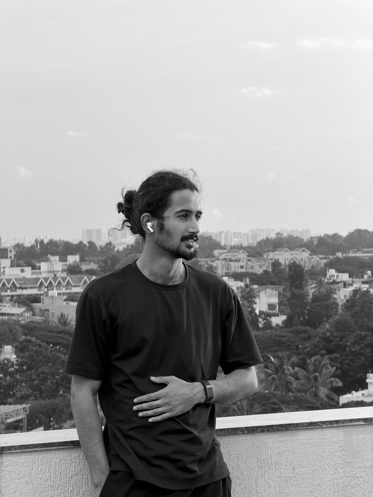Black-and-white rooftop portrait of Arham Amin